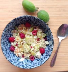 A colourful breakfast of oats with raspberries and feijoas